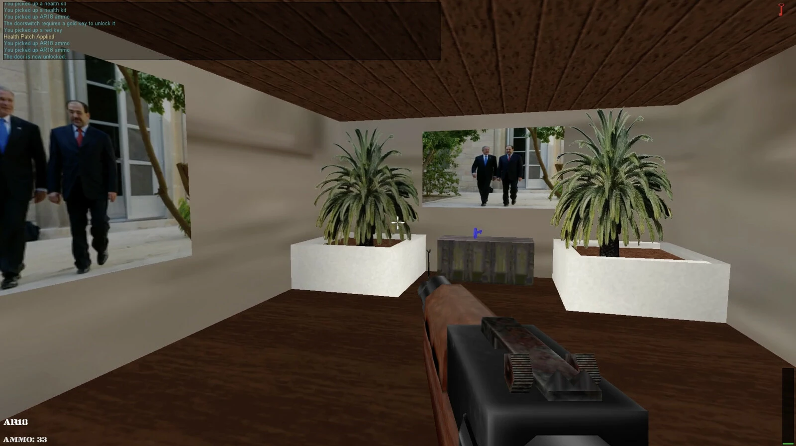 Rough animation of a room with two plants in big, white planters, and a gun that appears close to the foreground. Video stills of George Bush and Iraqi Prime Minister Nuri al-Maliki are featured on the walls.